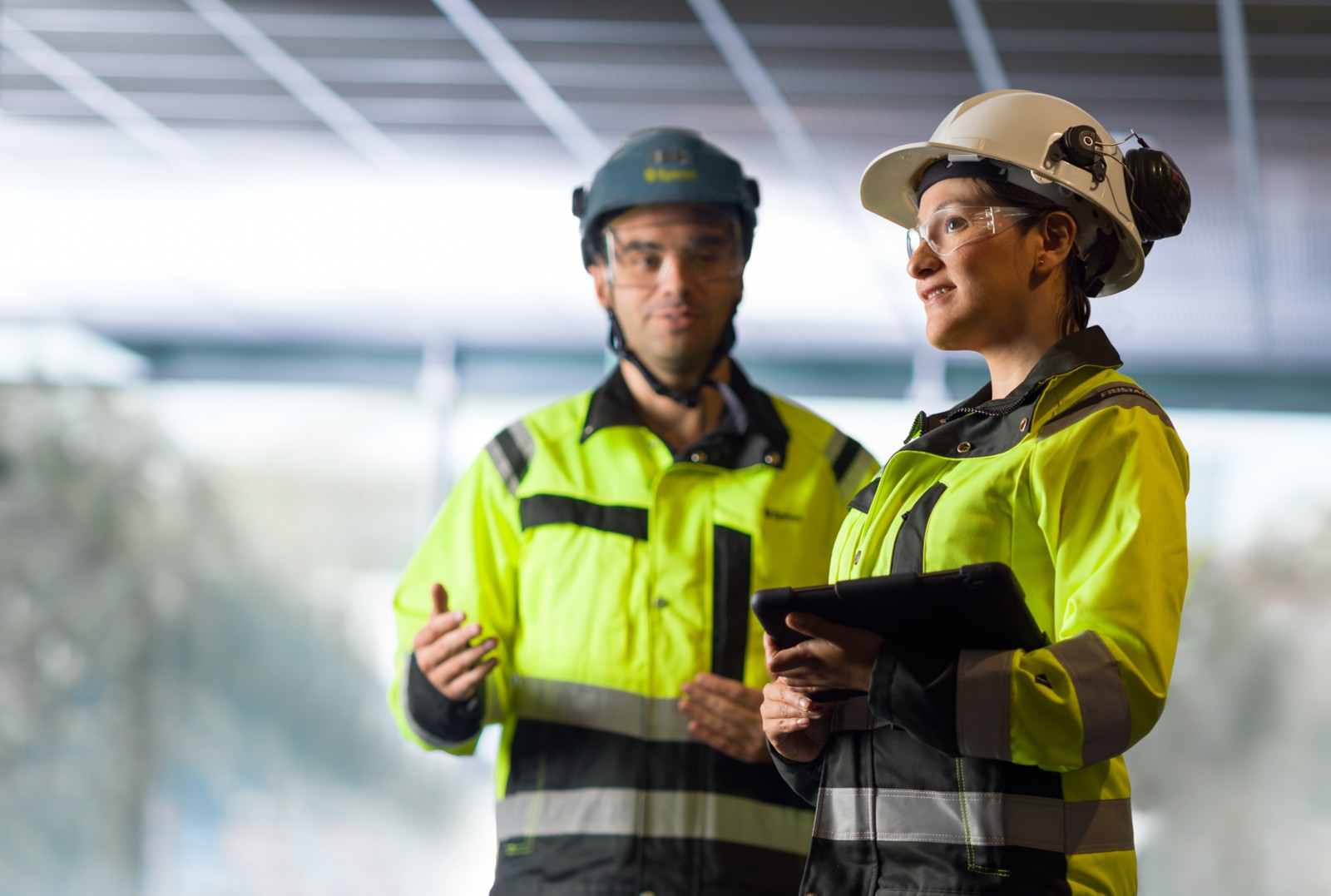 People_in_safety_gear.__Woman_holding_tablet._